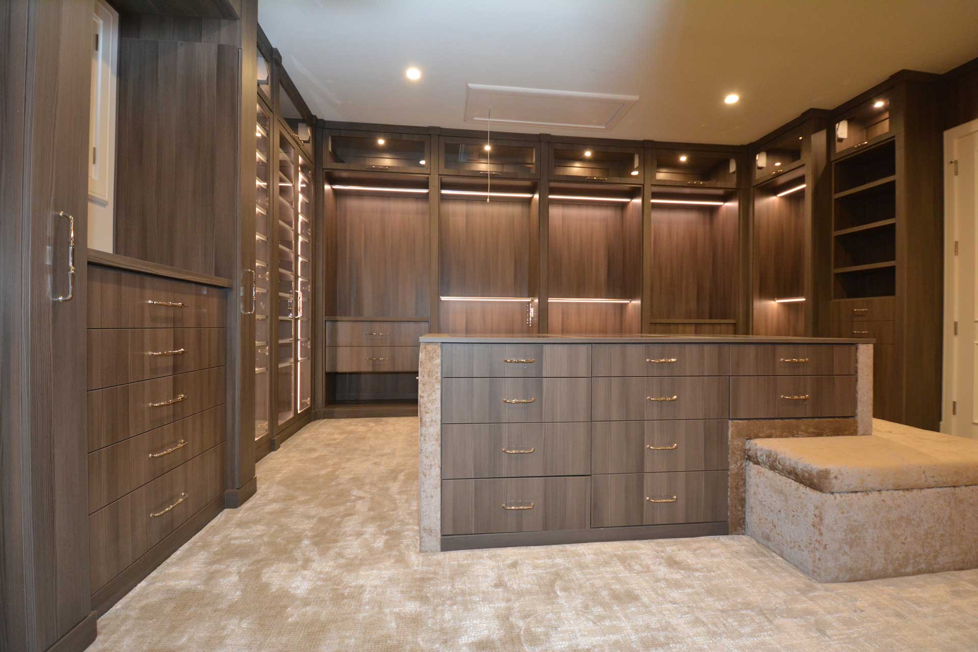 A spacious walk-in closet with ample storage and seating.